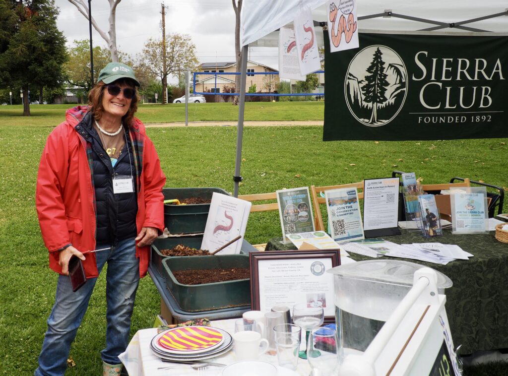 Volunteer showcasing environmental initiatives at SLO EarthFest.